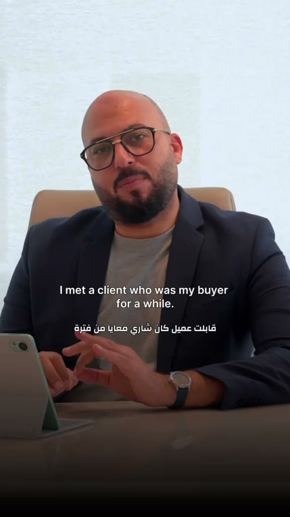 Mahmoud sharing a client story from his desk